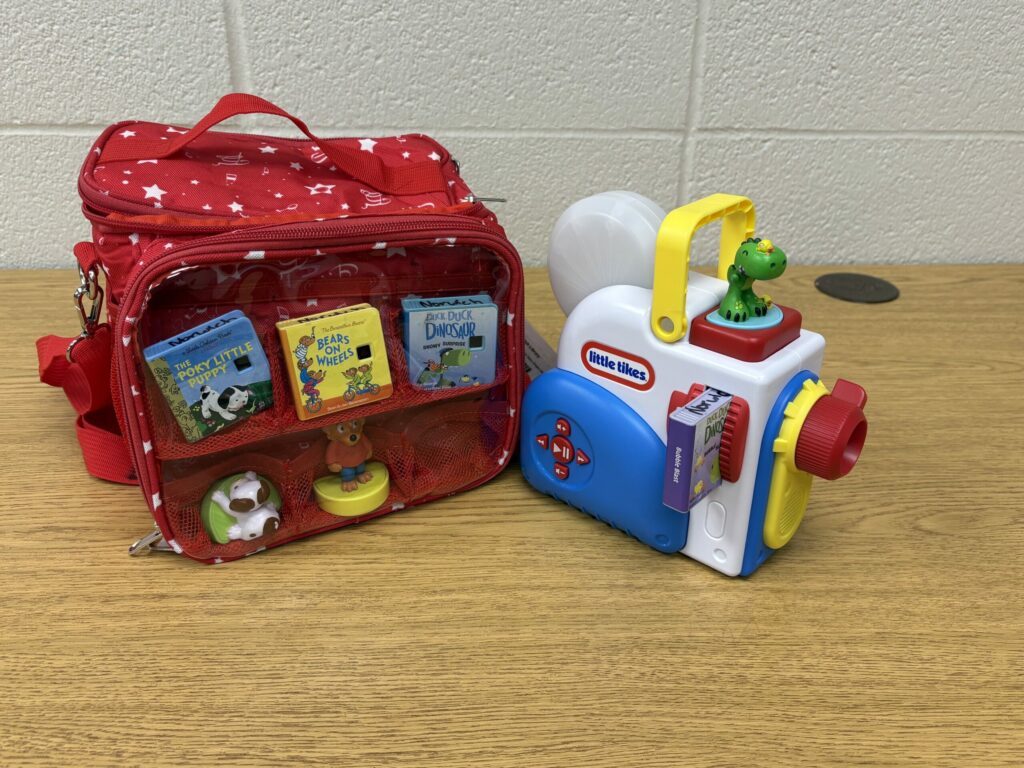 A kit consisting of a red and clear bag as well as a Little Tykes Dream Machine.
